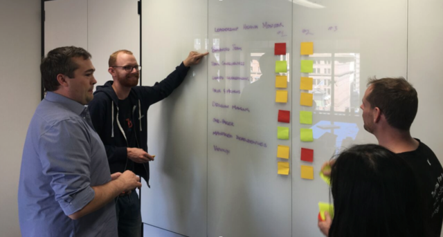 male colleages in front of a whiteboard
