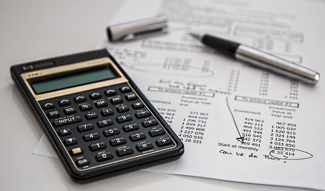 calculator and pen on desk