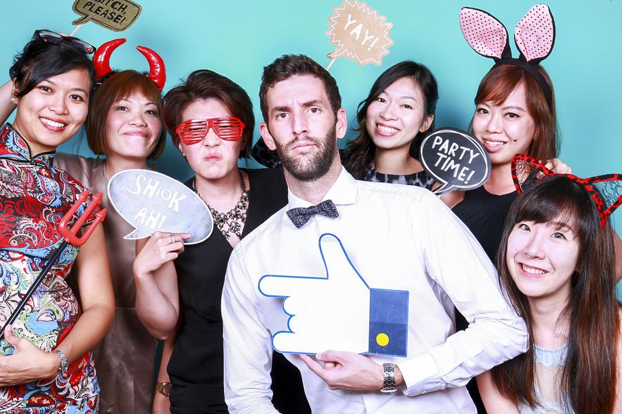 A group of 7 people dressed in party-wear posing for the camera